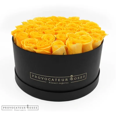 Caja redonda negra con rosas amarillas eternas